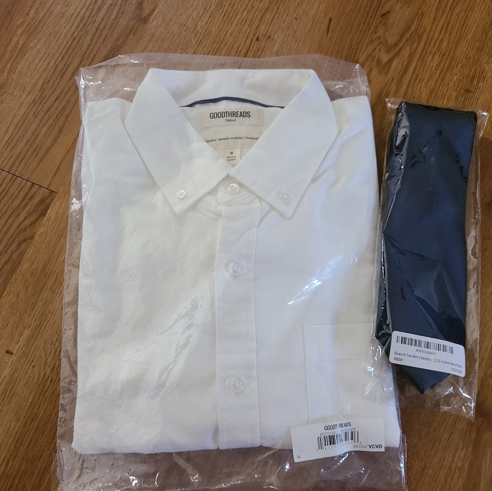 Long-sleeved white button up shirt with navy tie